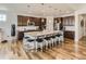 Modern kitchen with dark cabinets, granite countertops, and large island at 8803 S Winnipeg Ct, Aurora, CO 80016