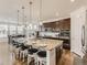Spacious kitchen boasts granite countertops, stainless steel appliances, and an island with seating at 8803 S Winnipeg Ct, Aurora, CO 80016
