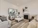 Living room with hardwood floors, fireplace, and ample seating at 8803 S Winnipeg Ct, Aurora, CO 80016