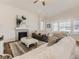 Open-concept living room with hardwood floors, fireplace, and views to kitchen at 8803 S Winnipeg Ct, Aurora, CO 80016