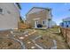 Well-maintained backyard featuring landscaping, stepping stones, and a small patio at 13589 E 102Nd Pl, Commerce City, CO 80022