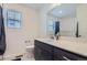 Clean bathroom featuring a single sink vanity and shower with tile surround, offering functionality and style at 13589 E 102Nd Pl, Commerce City, CO 80022