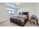 Inviting bedroom featuring plush carpeting, a large window for natural light, and a comfortable bed at 13589 E 102Nd Pl, Commerce City, CO 80022