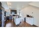 Open kitchen features stainless steel appliances, granite countertops, kitchen island, and ample cabinet space at 13589 E 102Nd Pl, Commerce City, CO 80022
