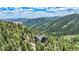 Beautiful mountain residence surrounded by lush green forest, offering scenic views at 14980 Elk Mountain Trl, Littleton, CO 80127