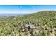 Majestic mountain home surrounded by dense forest, offering scenic views and privacy at 14980 Elk Mountain Trl, Littleton, CO 80127