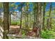 Wooded backyard retreat with mature trees, a split rail fence and scenic views at 14980 Elk Mountain Trl, Littleton, CO 80127