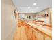 Basement bar area with custom wood cabinetry, LED lighting, and glass shelving for barware at 14980 Elk Mountain Trl, Littleton, CO 80127