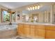 Bathroom with a dual sink vanity, soaking tub under a window, and walk-in shower at 14980 Elk Mountain Trl, Littleton, CO 80127