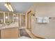 Bathroom features vanity with sink, mirror, and tile shower with glass door at 14980 Elk Mountain Trl, Littleton, CO 80127