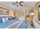 Bright bedroom with vaulted ceilings, ceiling fan, plush carpet, and mountain views at 14980 Elk Mountain Trl, Littleton, CO 80127