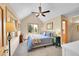 Bedroom with vaulted ceilings, plush carpet, ceiling fan, and plenty of natural light at 14980 Elk Mountain Trl, Littleton, CO 80127
