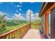 Wooden deck with red railings offering panoramic views of the surrounding mountains and landscape at 14980 Elk Mountain Trl, Littleton, CO 80127