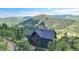 Stunning multi-story home nestled amongst the trees with mountain views at 14980 Elk Mountain Trl, Littleton, CO 80127