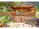 Stone exterior home with multi-level deck, beautiful stone patio, and access to a relaxing hot tub at 14980 Elk Mountain Trl, Littleton, CO 80127
