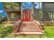 Inviting front entrance with red door, stone accents and flower planters at 14980 Elk Mountain Trl, Littleton, CO 80127