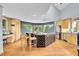 Spacious kitchen with light wood cabinets, granite island, and stainless appliances at 14980 Elk Mountain Trl, Littleton, CO 80127
