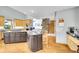 Gourmet kitchen featuring granite countertops, light wood cabinets, and breakfast bar at 14980 Elk Mountain Trl, Littleton, CO 80127