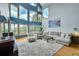 Bright living room boasts vaulted ceilings, large windows, hardwood floors, and comfortable neutral furnishings at 14980 Elk Mountain Trl, Littleton, CO 80127