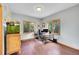 Home office featuring wood laminate flooring, a large desk, and an aquarium with natural light at 14980 Elk Mountain Trl, Littleton, CO 80127
