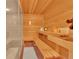 Relaxing in-home sauna with wood benches, wood walls and ceiling, and glass door entry at 14980 Elk Mountain Trl, Littleton, CO 80127