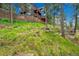 Landscaped backyard with lush lawn and mature trees, providing shade and a serene setting at 14980 Elk Mountain Trl, Littleton, CO 80127