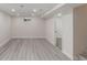 Spacious basement area with light gray flooring and neutral walls, providing ample living space at 2702 Atchison St, Aurora, CO 80011