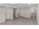 Finished basement with light gray flooring, white doors, and access to a remodeled bathroom at 2702 Atchison St, Aurora, CO 80011