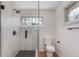 Modern bathroom featuring a frameless glass shower with marble-style tile and black hardware at 2702 Atchison St, Aurora, CO 80011