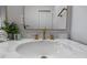 A close-up of the sink and vanity, highlighting the gold fixtures and marble countertop at 9379 Grandview Ave, Arvada, CO 80002