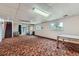 Spacious basement featuring colorful carpet, large windows, and access to the outdoors at 2122 S Yank Way, Lakewood, CO 80228