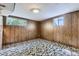 Basement bedroom features wood paneled walls and two windows for natural light at 2122 S Yank Way, Lakewood, CO 80228