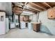 Basement area with washer/dryer, utility sink, and exposed ceiling at 2122 S Yank Way, Lakewood, CO 80228