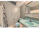 Bathroom with a shower, toilet and vanity with blue sink and accent at 2122 S Yank Way, Lakewood, CO 80228