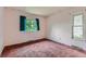 Bedroom with pink walls and brown carpet with large windows at 2122 S Yank Way, Lakewood, CO 80228