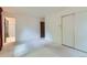 Bright bedroom featuring white walls, a large closet, and access to an ensuite bathroom at 2122 S Yank Way, Lakewood, CO 80228