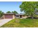 Charming one story ranch home featuring a two-car garage and mature landscaping at 2122 S Yank Way, Lakewood, CO 80228