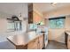 Kitchen featuring a center island with cooktop, ample cabinet space, and natural lighting at 2122 S Yank Way, Lakewood, CO 80228