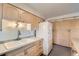 Kitchen featuring cream cabinets, laminate countertops, and white appliances at 2122 S Yank Way, Lakewood, CO 80228