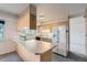 Kitchen featuring a center island with cooktop, ample cabinet space, and white appliances at 2122 S Yank Way, Lakewood, CO 80228