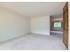 Bright and airy living room showcasing neutral carpeting and a seamless flow to the dining area at 2122 S Yank Way, Lakewood, CO 80228