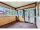 Sunroom with multiple windows, neutral carpet, and access to the outside at 2122 S Yank Way, Lakewood, CO 80228