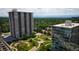 High-rise buildings with manicured gardens, tennis courts, and lush greenery, blending city and nature at 3131 E Alameda Ave # 1604, Denver, CO 80209