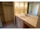 Bathroom boasts stone countertop, wood-toned cabinets, and a large mirror at 3131 E Alameda Ave # 1604, Denver, CO 80209