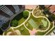 Overhead view of complex's meticulously landscaped grounds with tennis court, walking paths, and seating at 3131 E Alameda Ave # 1604, Denver, CO 80209