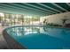 Large indoor pool features floor-to-ceiling windows with outdoor views and multiple seating areas at 3131 E Alameda Ave # 1604, Denver, CO 80209