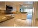 Kitchen features white cabinets, granite countertops and white appliances, seamlessly flowing into the living area at 3131 E Alameda Ave # 1604, Denver, CO 80209