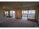Living room with neutral carpeting, large windows, and an adjacent space for relaxation and entertainment at 3131 E Alameda Ave # 1604, Denver, CO 80209