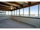 Light-filled living room with city views from numerous windows, cozy carpeting and a modern ceiling fan at 3131 E Alameda Ave # 1604, Denver, CO 80209