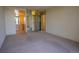Spacious living room boasts neutral carpet, natural light and access to bathroom and closet with mirrored sliding doors at 3131 E Alameda Ave # 1604, Denver, CO 80209